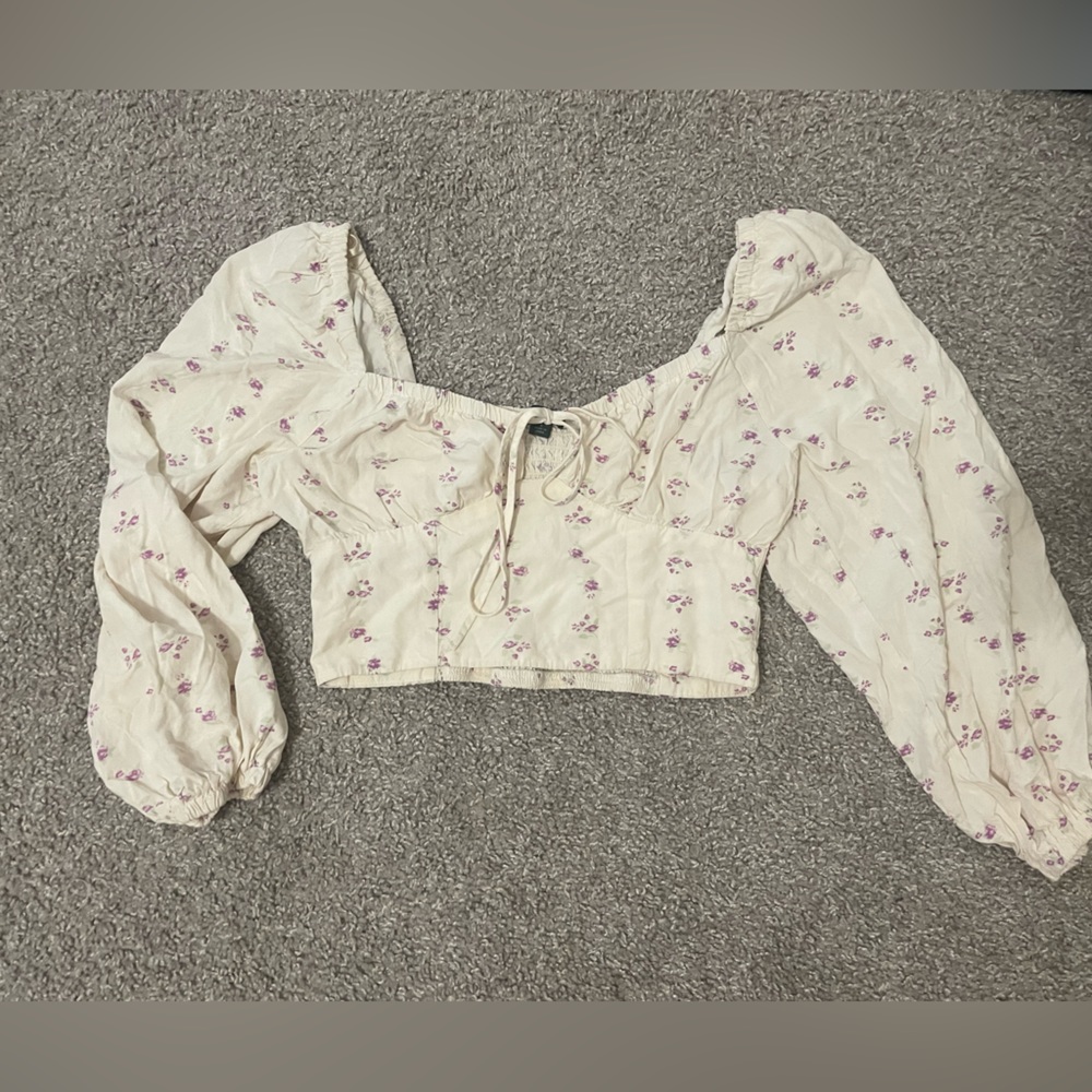 long sleeve corset-like crop top with flowers on it